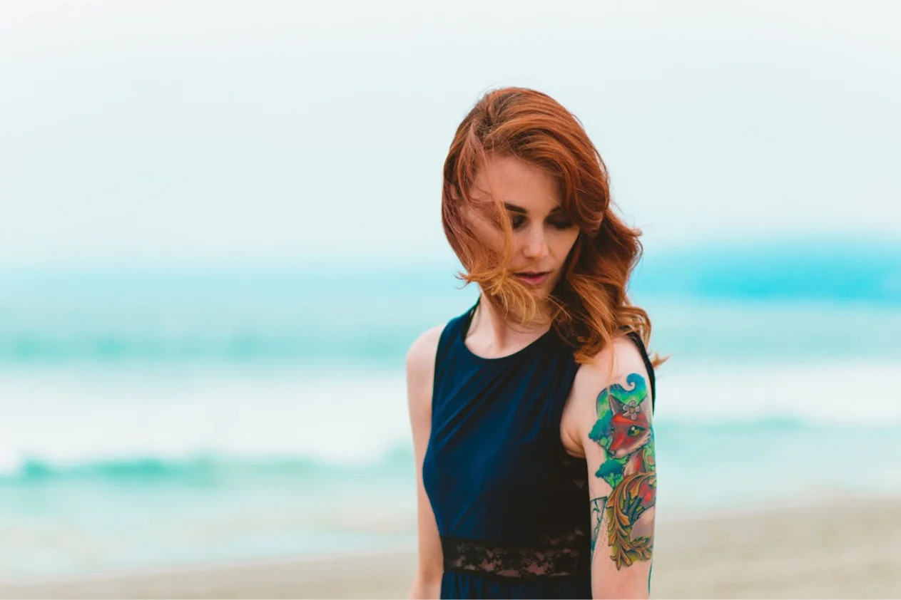 Woman with tattoo on the beach