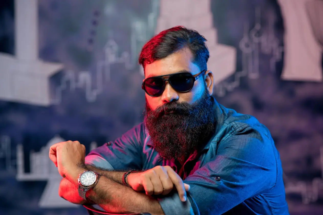 A man with a bushy beard and sunglasses