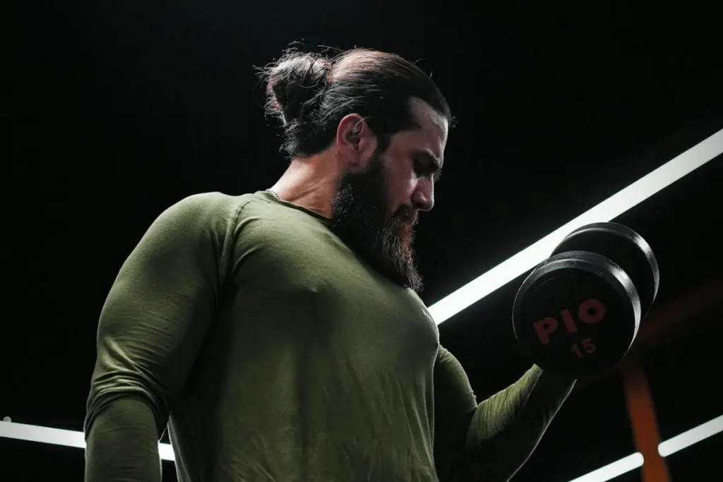man with mustache lifting weights