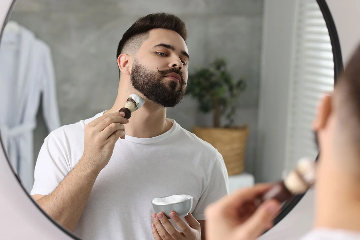 a man shaving in front of the mirror
