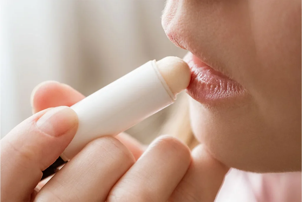 woman applying lip balm