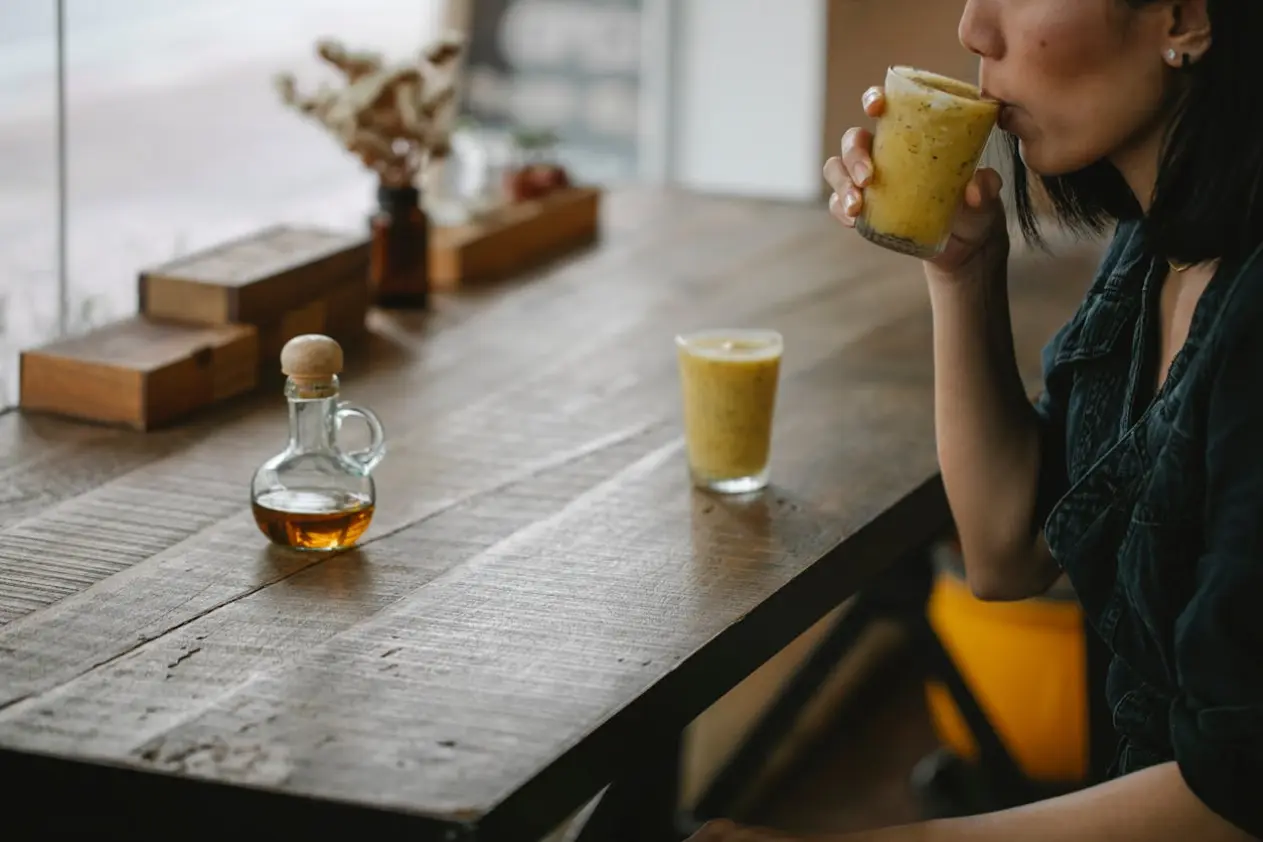 Woman drinking a juice with honey and pollen and bee juice
